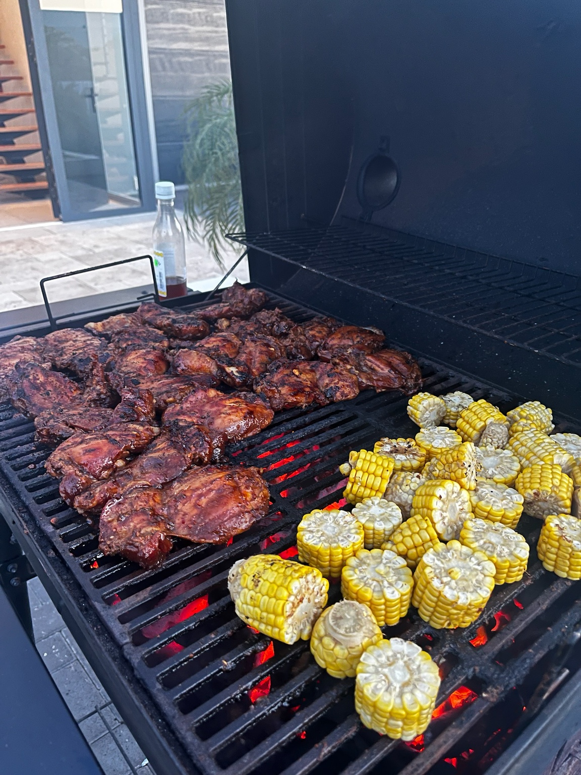 BBQ Queen grilling meats and corn